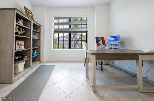 office area with plenty of natural light, baseboards, and light tile patterned floors