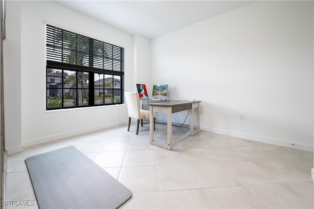 home office featuring tile patterned flooring and baseboards