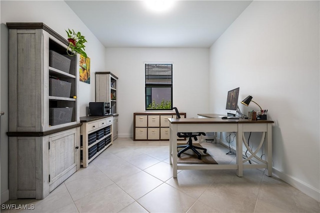 office featuring baseboards and light tile patterned floors