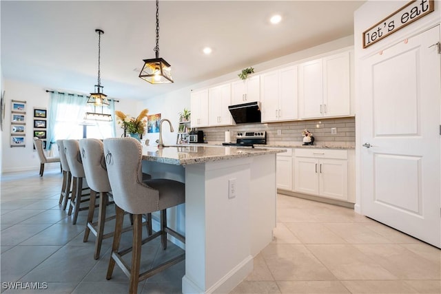 kitchen featuring decorative backsplash, light tile patterned flooring, stainless steel electric stove, and a sink