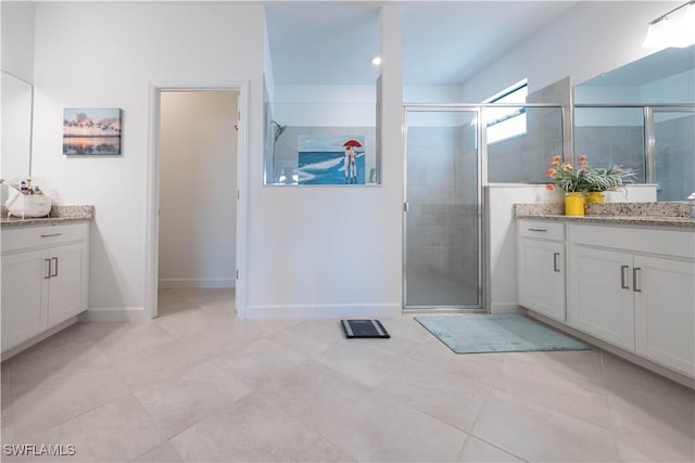 bathroom featuring vanity, baseboards, a shower stall, and tile patterned flooring