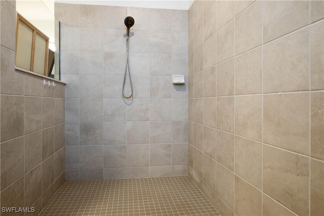 bathroom with a tile shower