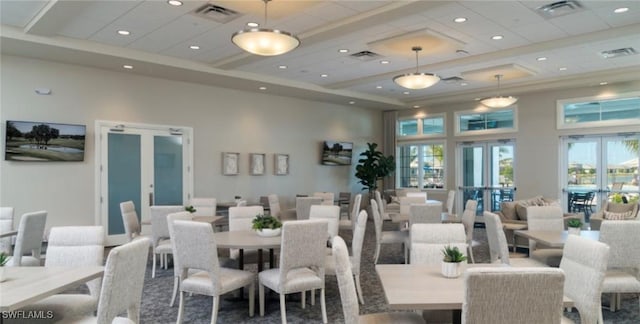 dining space featuring visible vents, french doors, and a high ceiling