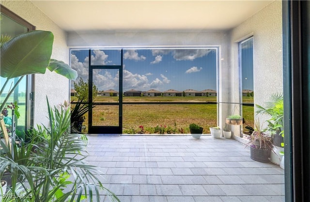 unfurnished sunroom featuring a textured wall