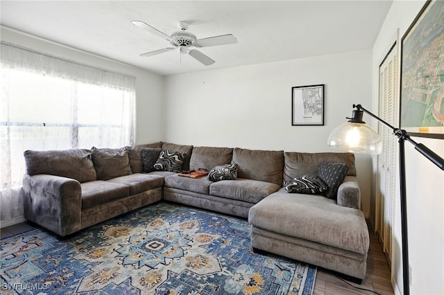 living room featuring a ceiling fan and wood finished floors
