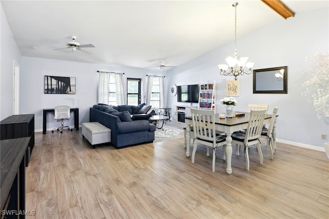 dining space with light wood finished floors, baseboards, ceiling fan with notable chandelier, and vaulted ceiling with beams