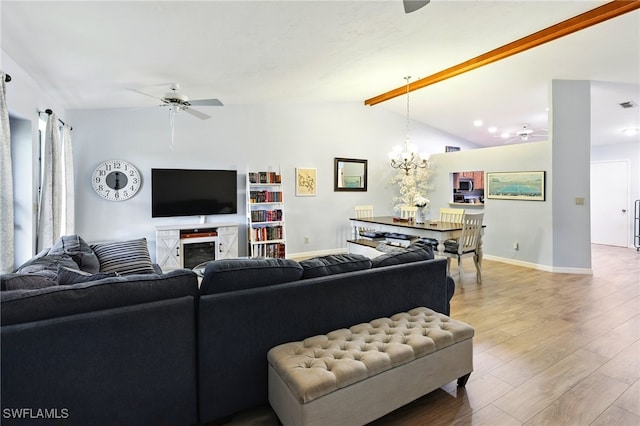 living area featuring ceiling fan with notable chandelier, visible vents, vaulted ceiling with beams, baseboards, and light wood-style floors