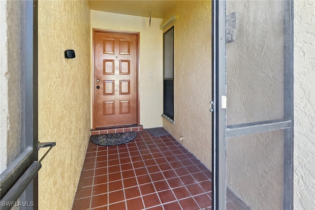 entrance to property with stucco siding