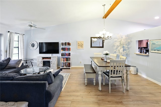 dining area with baseboards, light wood-style flooring, ceiling fan with notable chandelier, and lofted ceiling with beams