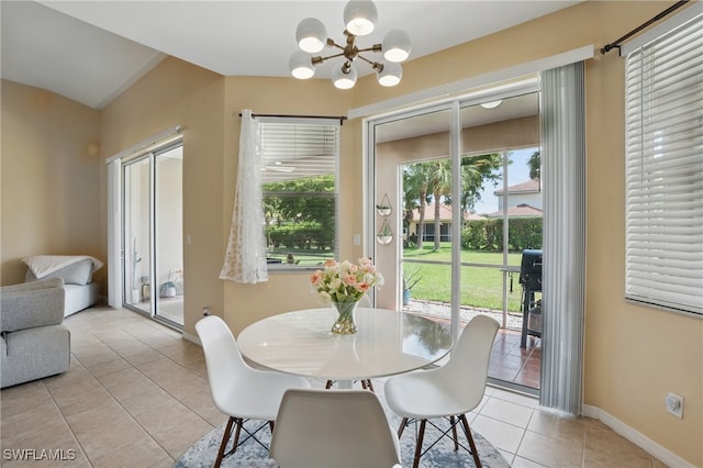 dining room with light tile patterned floors, a chandelier, and baseboards