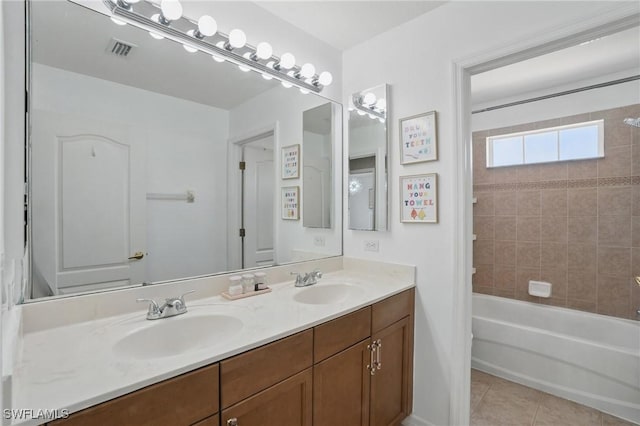 bathroom with tile patterned floors, double vanity, and  shower combination