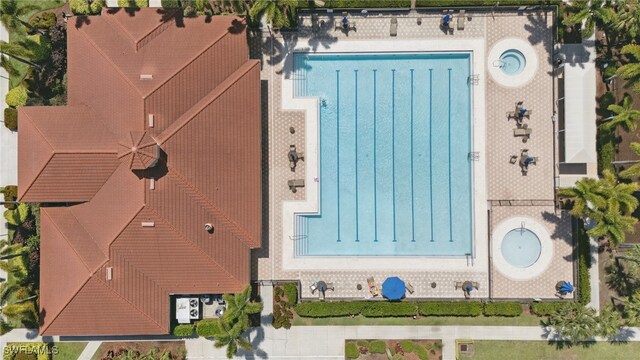 aerial view of property and surrounding area featuring a pool