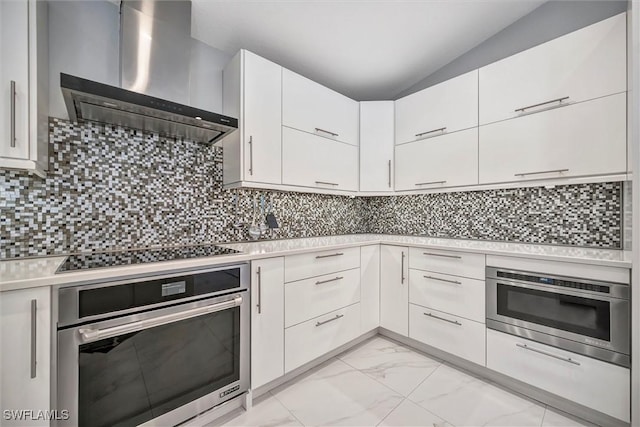 6953 Wittman Dr, Fort Myers, FL 33919 - kitchen with stainless steel oven, wall chimney range hood, black electric cooktop, light countertops, and white cabinets