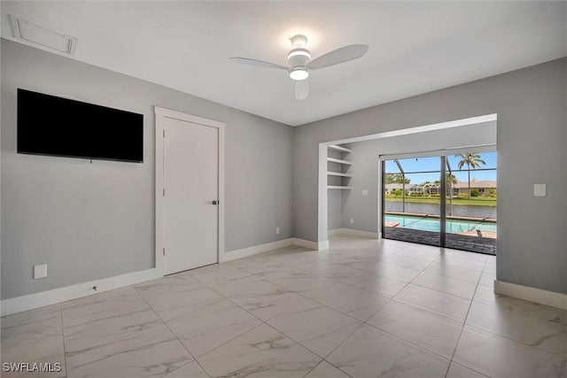 6953 Wittman Dr, Fort Myers, FL 33919 - empty room with light marble finish flooring, baseboards, and a ceiling fan