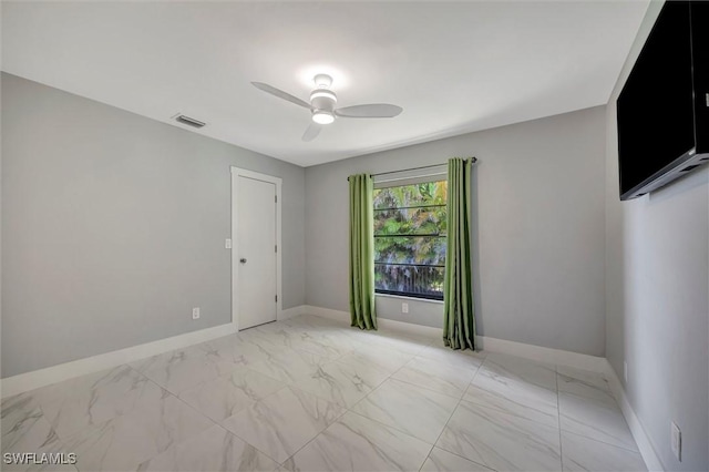 6953 Wittman Dr, Fort Myers, FL 33919 - unfurnished room featuring ceiling fan, light marble finish floors, and baseboards