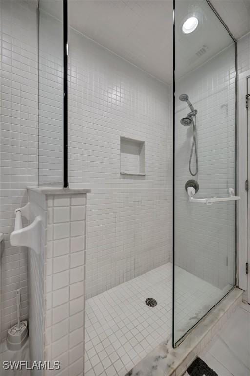6953 Wittman Dr, Fort Myers, FL 33919 - bathroom with a stall shower, tile walls, and tile patterned flooring