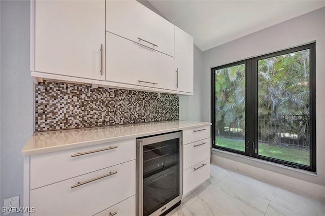 6953 Wittman Dr, Fort Myers, FL 33919 - bar area featuring beverage cooler, light marble finish floors, and backsplash