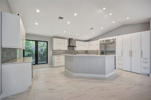 6953 Wittman Dr, Fort Myers, FL 33919 - kitchen with light marble finish flooring, wall chimney range hood, a center island, lofted ceiling, and decorative backsplash