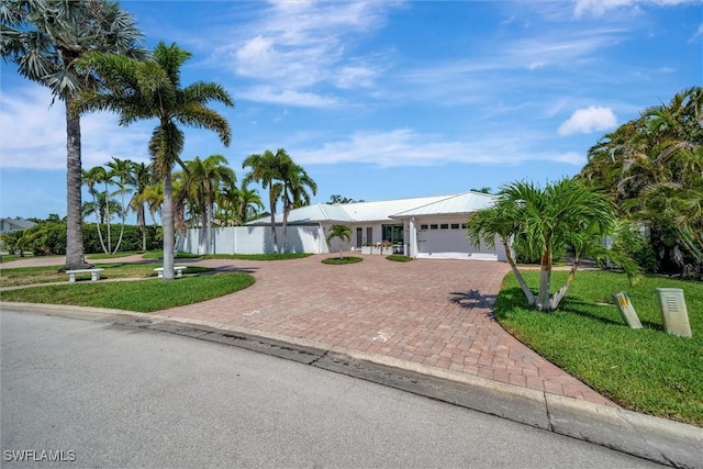 6953 Wittman Dr, Fort Myers, FL 33919 - single story home featuring decorative driveway, an attached garage, and metal roof