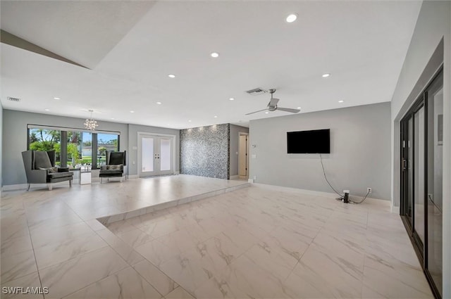 6953 Wittman Dr, Fort Myers, FL 33919 - unfurnished living room featuring recessed lighting, baseboards, ceiling fan, a chandelier, and french doors