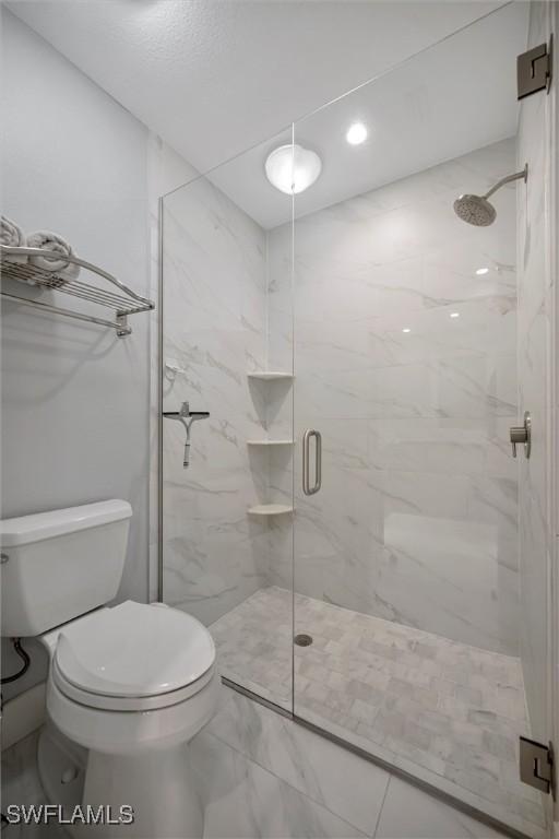 6953 Wittman Dr, Fort Myers, FL 33919 - bathroom with marble finish floors, a marble finish shower, and toilet