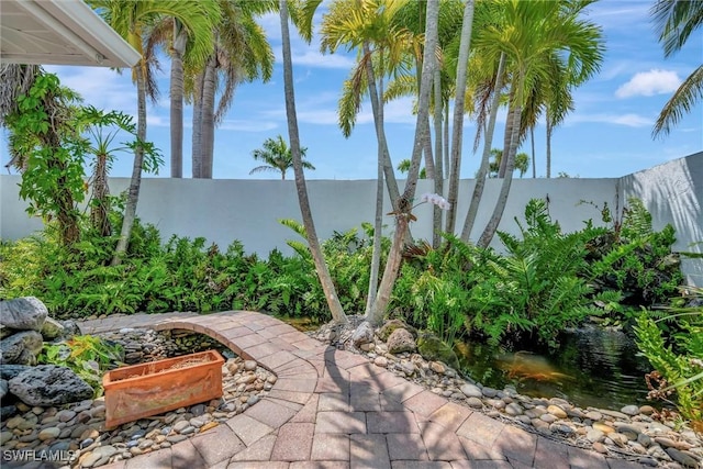 6953 Wittman Dr, Fort Myers, FL 33919 - view of patio / terrace with a garden pond