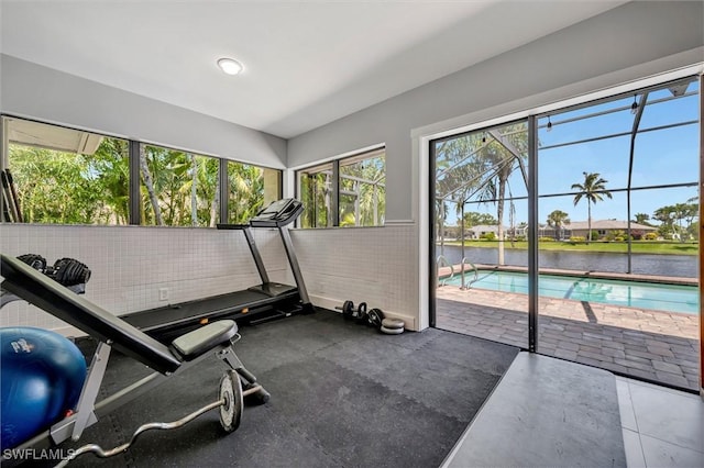 6953 Wittman Dr, Fort Myers, FL 33919 - exercise room featuring a sunroom and a water view