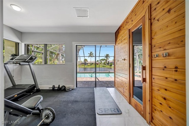 6953 Wittman Dr, Fort Myers, FL 33919 - exercise room featuring wooden walls