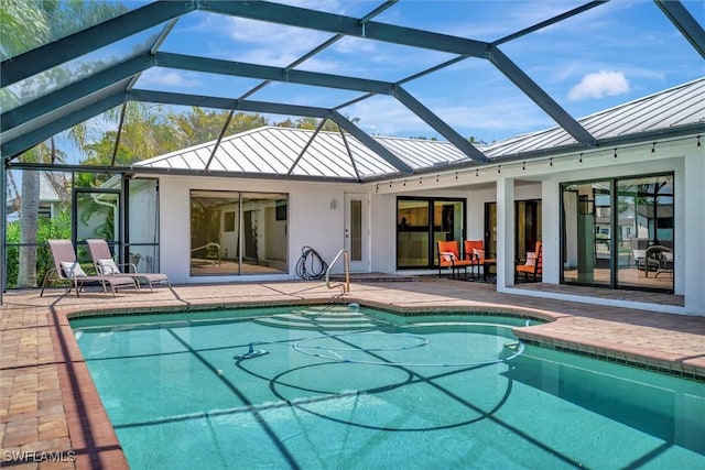 6953 Wittman Dr, Fort Myers, FL 33919 - rear view of house with a standing seam roof, metal roof, a patio area, and an outdoor pool