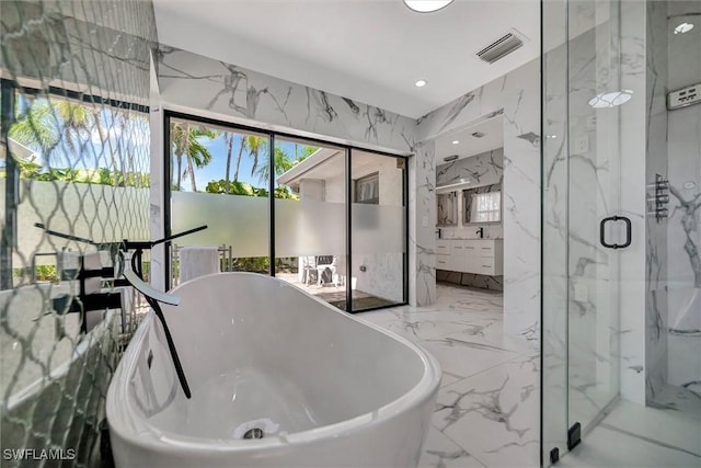 6953 Wittman Dr, Fort Myers, FL 33919 - bathroom with marble tiled floors, a marble finish shower, vanity, a soaking tub, and recessed lighting