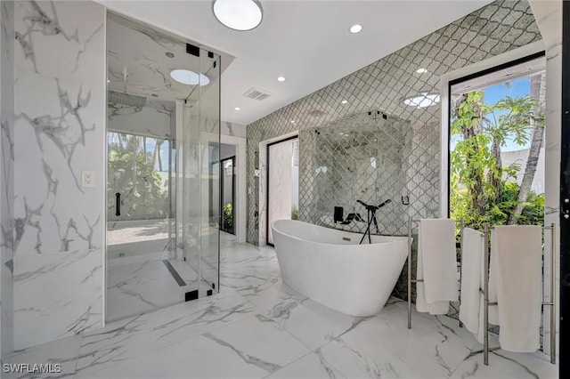 6953 Wittman Dr, Fort Myers, FL 33919 - bathroom with a marble finish shower, a soaking tub, stone wall, recessed lighting, and healthy amount of natural light