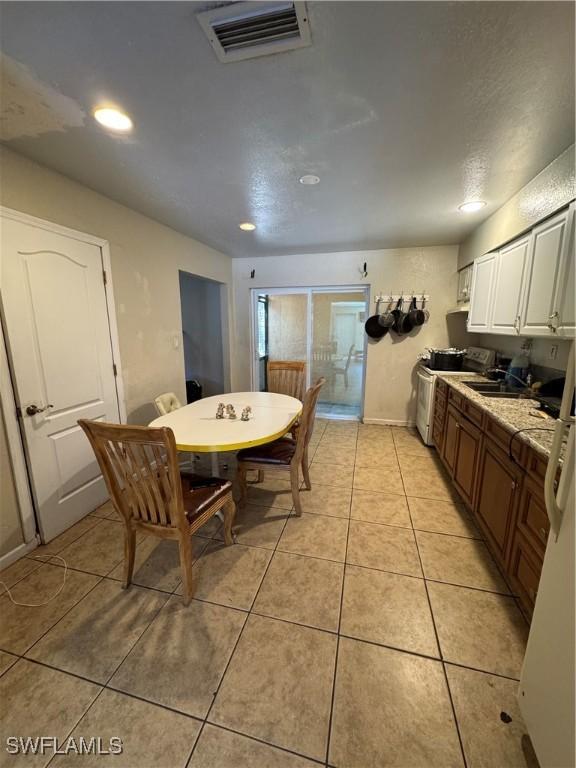 27831 Quinn St, Bonita Springs, FL 34135 - kitchen featuring visible vents, recessed lighting, white electric range oven, light tile patterned floors, and white cabinets
