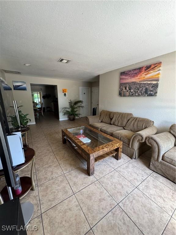 27831 Quinn St, Bonita Springs, FL 34135 - living area with a textured ceiling, visible vents, and light tile patterned flooring