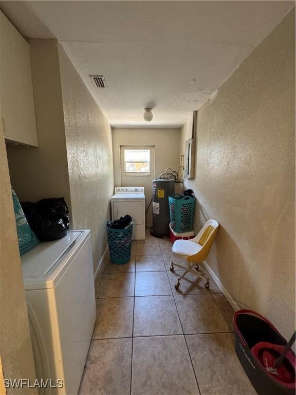 27831 Quinn St, Bonita Springs, FL 34135 - clothes washing area featuring laundry area, visible vents, a textured wall, electric water heater, and light tile patterned flooring