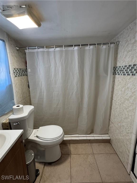 27831 Quinn St, Bonita Springs, FL 34135 - full bath with tile walls, toilet, a shower with shower curtain, and vanity
