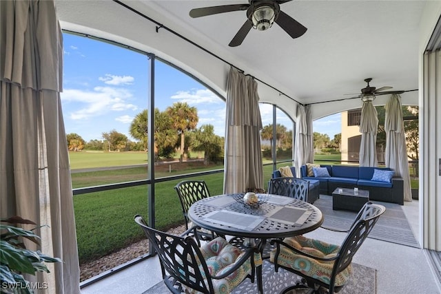 sunroom / solarium featuring a ceiling fan, golf course view, and an outdoor hangout area