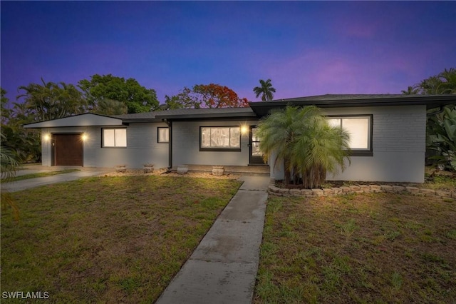 1331 Rio Vista Ave, Fort Myers, FL 33901 - ranch-style home with an attached garage, a lawn, brick siding, and driveway