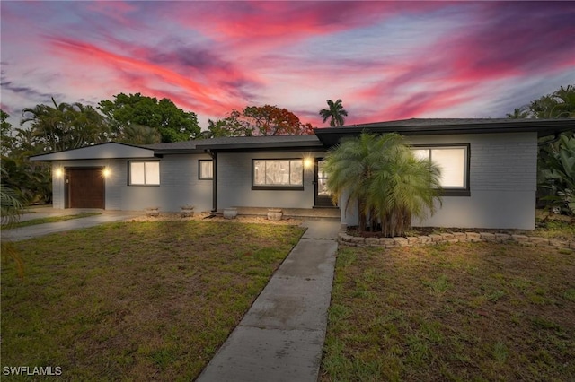 1331 Rio Vista Ave, Fort Myers, FL 33901 - ranch-style house featuring a front yard, an attached garage, and brick siding