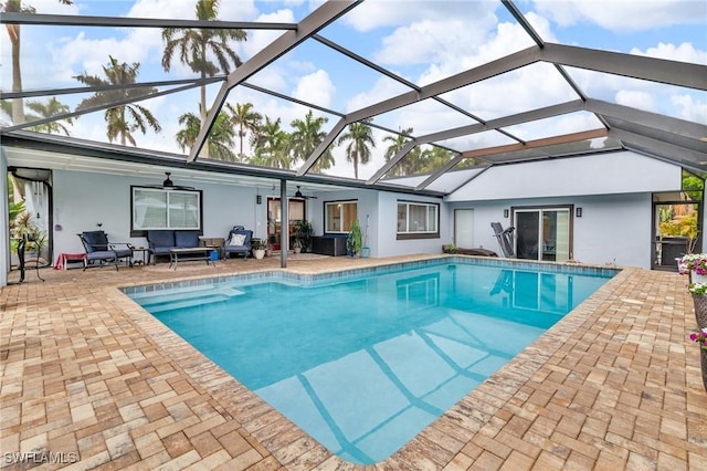 1331 Rio Vista Ave, Fort Myers, FL 33901 - swimming pool featuring a ceiling fan, an outdoor hangout area, a patio, and glass enclosure