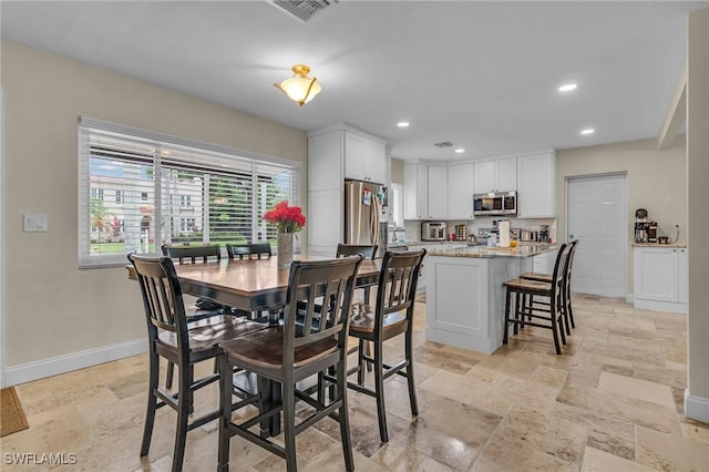 1331 Rio Vista Ave, Fort Myers, FL 33901 - dining area featuring stone tile floors, baseboards, and recessed lighting