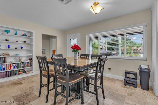 1331 Rio Vista Ave, Fort Myers, FL 33901 - dining space with stone tile floors, baseboards, and built in shelves