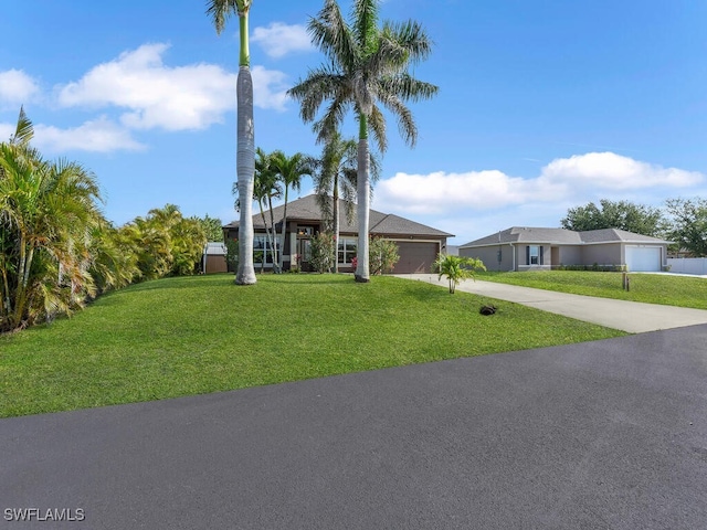 621 NW 28th Ter, Cape Coral, FL 33993 - view of front facade with concrete driveway, a garage, and a front yard