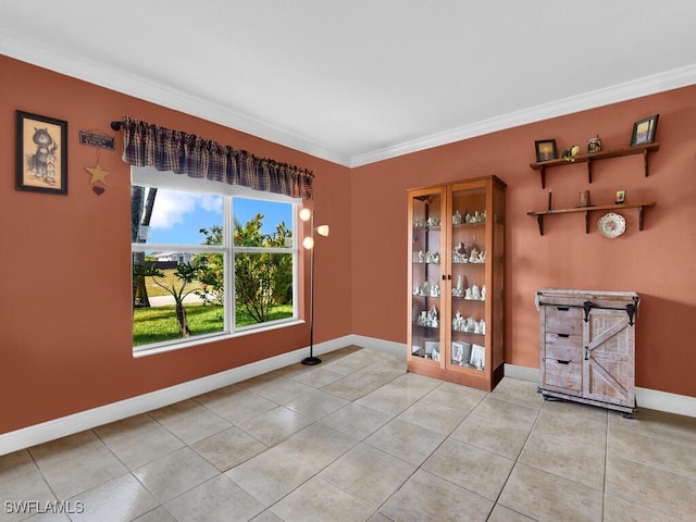 621 NW 28th Ter, Cape Coral, FL 33993 - spare room with ornamental molding, baseboards, and light tile patterned floors