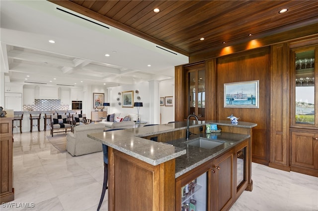 1520 Star Point Ln Unit 4-401, Naples, FL 34112 - kitchen with a sink, light marble finish flooring, tasteful backsplash, open floor plan, and a center island with sink