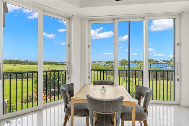 1520 Star Point Ln Unit 4-401, Naples, FL 34112 - sunroom featuring a water view, plenty of natural light, and tile patterned flooring
