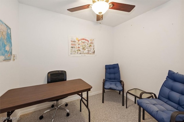 office featuring light carpet, baseboards, and a ceiling fan