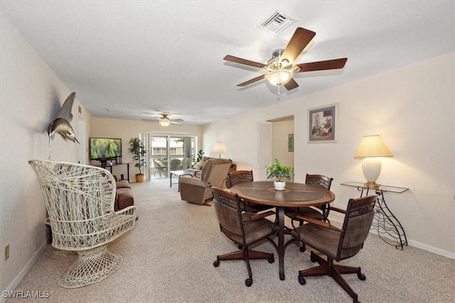 carpeted dining area with ceiling fan, baseboards, and visible vents