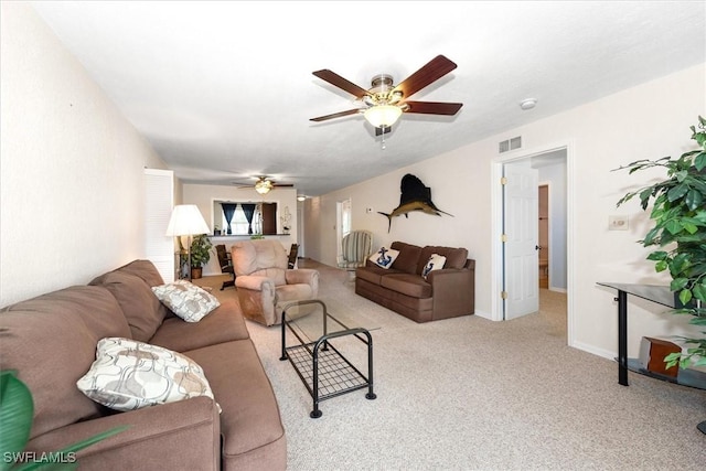 living area with ceiling fan, visible vents, and carpet floors