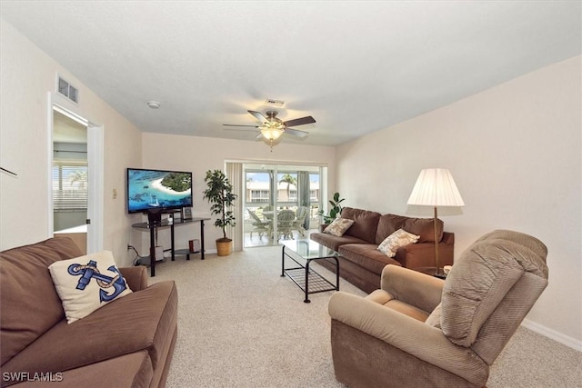 carpeted living room with ceiling fan and visible vents