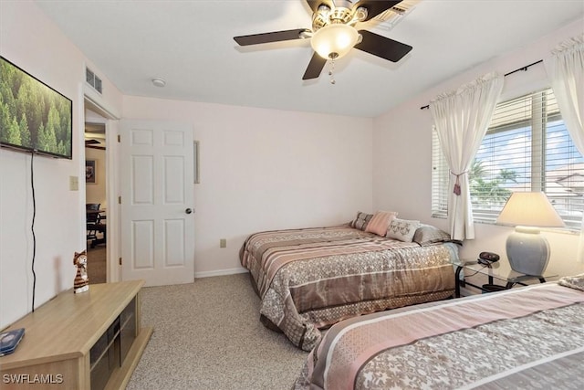 bedroom with carpet, visible vents, and ceiling fan